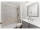 Modern bathroom featuring a walk-in shower, gray vanity, a large mirror, and sleek fixtures at 4135 Iveyglen Ave, Orlando, FL 32826