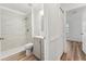 Bathroom featuring a gray vanity, tile backsplash, walk-in shower, and wood-look floor at 4135 Iveyglen Ave, Orlando, FL 32826