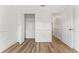 Neutral bedroom featuring wood-look laminate flooring, closet, and white trim at 4135 Iveyglen Ave, Orlando, FL 32826