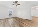 Bright bedroom featuring wood floors, a ceiling fan, and a large window for natural light at 4135 Iveyglen Ave, Orlando, FL 32826