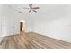 This bedroom features new flooring, a ceiling fan, a neutral paint palette, and archway details at 4135 Iveyglen Ave, Orlando, FL 32826