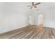 Bedroom featuring new flooring, a ceiling fan, a neutral paint palette, and archway details at 4135 Iveyglen Ave, Orlando, FL 32826