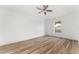 Bright bedroom featuring wood floors, a ceiling fan, and a large window for natural light at 4135 Iveyglen Ave, Orlando, FL 32826