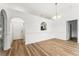 Open-concept dining room with wood-look floors and neutral paint, and arched doorways at 4135 Iveyglen Ave, Orlando, FL 32826