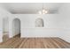 Dining room featuring wood flooring, archway details, and modern lighting fixtures at 4135 Iveyglen Ave, Orlando, FL 32826