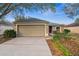 Single Gathering home with a two-car garage, complemented by a well-maintained lawn at 4135 Iveyglen Ave, Orlando, FL 32826