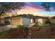 Charming one-story home with a well-manicured lawn and inviting red front door at 4135 Iveyglen Ave, Orlando, FL 32826