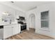 Modern kitchen featuring stainless steel appliances, white cabinetry, and wood-style flooring at 4135 Iveyglen Ave, Orlando, FL 32826