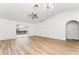 Bright living room featuring wood-style floors, white walls, and sliding glass doors to the backyard at 4135 Iveyglen Ave, Orlando, FL 32826