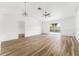 Spacious living room featuring wood-style floors, white walls, and sliding glass doors to the backyard at 4135 Iveyglen Ave, Orlando, FL 32826