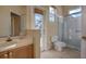 Bright bathroom with a tiled shower, a walkout to the pool, and a vanity sink at 418 Laurenburg Ln, Ocoee, FL 34761