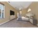 Main bedroom featuring neutral carpet and walls, ceiling fan, ample natural light, and an ensuite bathroom at 418 Laurenburg Ln, Ocoee, FL 34761