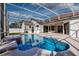 View of the blue swimming pool with spa and patio in a screened-in enclosure at 418 Laurenburg Ln, Ocoee, FL 34761