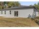 Exterior of home showcasing sliding glass doors leading to a patio and backyard at 4405 Sw 155Th Place Rd, Ocala, FL 34473