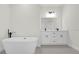 Bright bathroom featuring double vanity, black fixtures, quartz counters, and a modern soaking tub at 4405 Sw 155Th Place Rd, Ocala, FL 34473