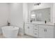 Spa-like bathroom with a freestanding tub, dual vanities, quartz counters, and modern black fixtures at 4405 Sw 155Th Place Rd, Ocala, FL 34473