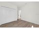 Bedroom showcasing wood-look flooring, neutral paint, and a closet for organized storage at 4405 Sw 155Th Place Rd, Ocala, FL 34473