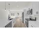 Modern kitchen featuring white cabinetry, stainless steel appliances, quartz countertops, and a view of the backyard at 4405 Sw 155Th Place Rd, Ocala, FL 34473