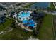 Aerial view of the community pool, clubhouse and playground, surrounded by lush landscaping at 5116 Rain Shadow Dr, St Cloud, FL 34772