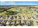 Overhead view of homes in a golf course community surrounded by water and greenery at 53 High Vista Dr, Davenport, FL 33837