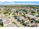 Overhead view of a well-maintained community with tennis courts and lush green landscape at 53 High Vista Dr, Davenport, FL 33837