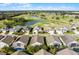 Aerial view of homes with screened-in pools, near a golf course under a clear sky at 53 High Vista Dr, Davenport, FL 33837