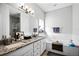 Bright bathroom featuring double sinks, granite countertop, large mirror, and tub at 53 High Vista Dr, Davenport, FL 33837