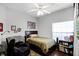 Comfortable bedroom features a ceiling fan, window, bed and a chair at 53 High Vista Dr, Davenport, FL 33837