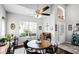 Bright dining area with a round table, ceiling fan, and a large window for natural light at 53 High Vista Dr, Davenport, FL 33837