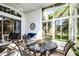 Enclosed sunroom with a ceiling fan and a patio furniture set with view to green outdoor space at 53 High Vista Dr, Davenport, FL 33837