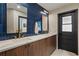 Modern bathroom featuring double sinks, sleek countertops, and stylish blue tile backsplash at 5447 Brookline Dr, Orlando, FL 32819