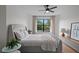 Cozy bedroom with a large window, a comfortable gray bed, and modern furnishings at 5447 Brookline Dr, Orlando, FL 32819