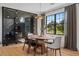 Dining room boasts wine cellar, designer light fixture, and a backyard view through a large window at 5447 Brookline Dr, Orlando, FL 32819