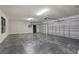 Well-lit garage with epoxy flooring and multiple garage door openers for convenience at 5447 Brookline Dr, Orlando, FL 32819