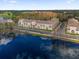 Aerial view of multi-story condos near a lake and tree lined street at 706 Westpark Way # 203, Celebration, FL 34747