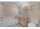 Tiled bathroom featuring a tub and shower combination and updated vanity at 706 Westpark Way # 203, Celebration, FL 34747