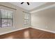 Bedroom with wood-look flooring and two windows at 706 Westpark Way # 203, Celebration, FL 34747