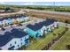 Aerial view of colorful homes, lush landscaping and the beautiful community providing a sense of place at 8179 Coconut Pl, Kissimmee, FL 34747