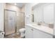 Well-lit bathroom with a glass shower, a modern sink with quartz counters and a large mirror at 8179 Coconut Pl, Kissimmee, FL 34747