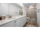 Modern bathroom featuring dual sinks, a spacious shower, and clean design for a spa-like experience at 8179 Coconut Pl, Kissimmee, FL 34747