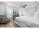 Inviting bedroom featuring natural light from the windows and a ceiling fan, creating a peaceful space at 8179 Coconut Pl, Kissimmee, FL 34747