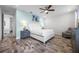 Bright and airy bedroom with stylish decor, a ceiling fan, and a comfortable seating area at 8179 Coconut Pl, Kissimmee, FL 34747