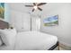 Comfortable bedroom featuring a ceiling fan and a wall-mounted television for relaxation at 8179 Coconut Pl, Kissimmee, FL 34747