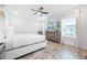 Cozy bedroom offering natural light from the windows and a ceiling fan, creating a warm ambiance at 8179 Coconut Pl, Kissimmee, FL 34747