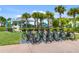 Convenient bike rack with multiple bikes near a cafe and picturesque tropical landscaping in a resort setting at 8179 Coconut Pl, Kissimmee, FL 34747