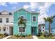 Charming two-story home with modern design and colorful, tropical facade at 8179 Coconut Pl, Kissimmee, FL 34747