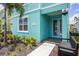 Exterior of a two-story townhome, with walkway, landscaping, bench and lighting at 8179 Coconut Pl, Kissimmee, FL 34747