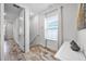 Hallway with hardwood floors and a window with a view, creating a bright, welcoming space at 8179 Coconut Pl, Kissimmee, FL 34747