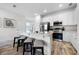 White kitchen featuring an island with barstool seating, and stainless appliances at 8179 Coconut Pl, Kissimmee, FL 34747