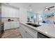 Modern kitchen with stainless steel appliances, island with sink and margarita maker, and an adjacent living room at 8179 Coconut Pl, Kissimmee, FL 34747